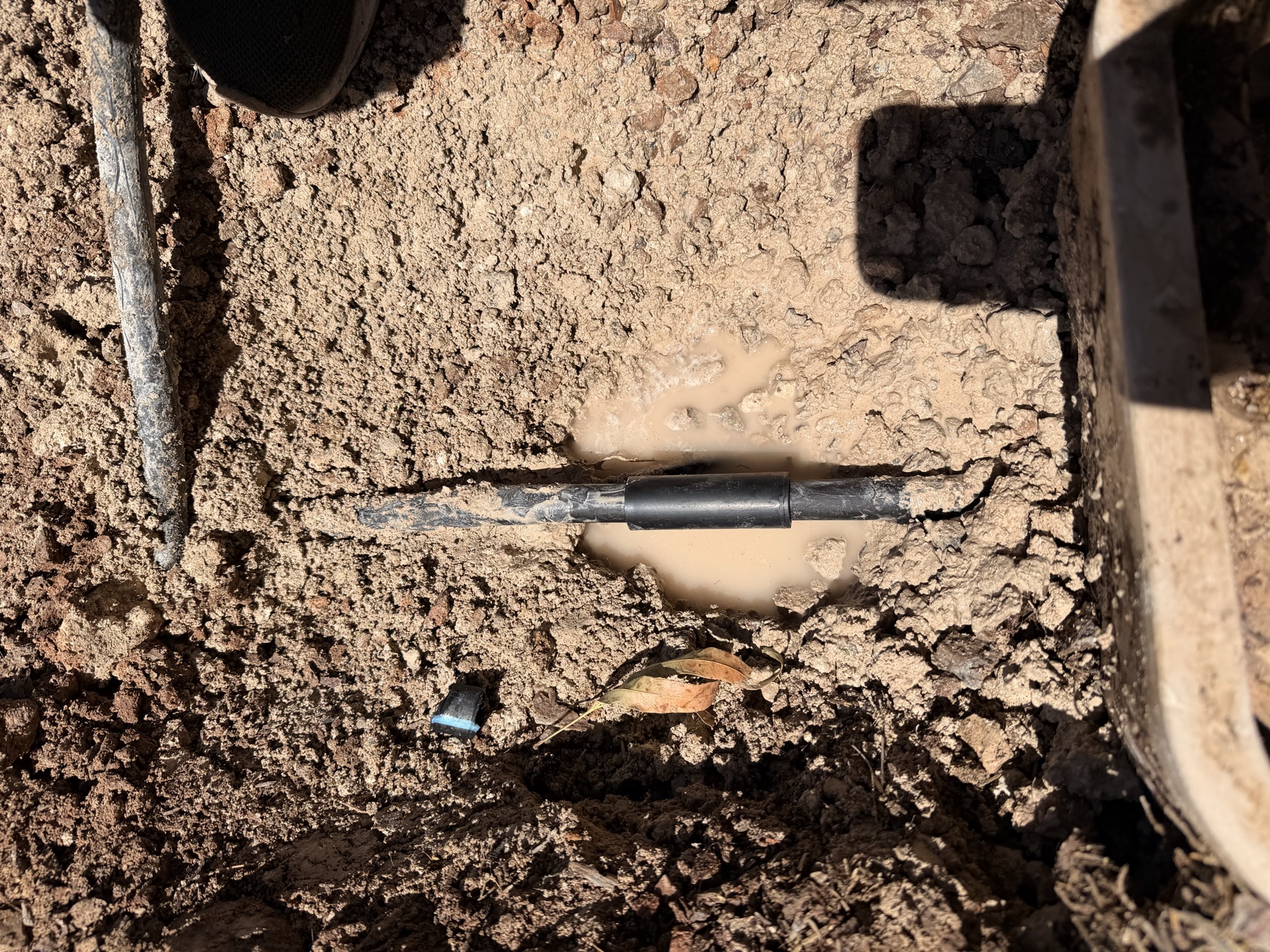 Irrigation line repair work completed below the landscape surface