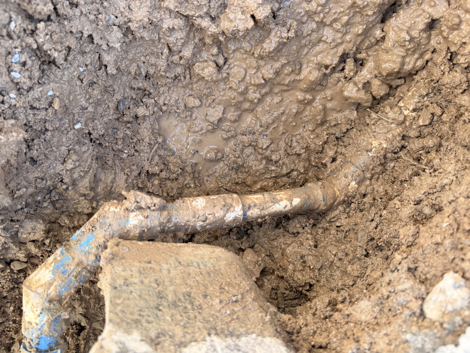 Leak repair work on an exposed underground irrigation connection