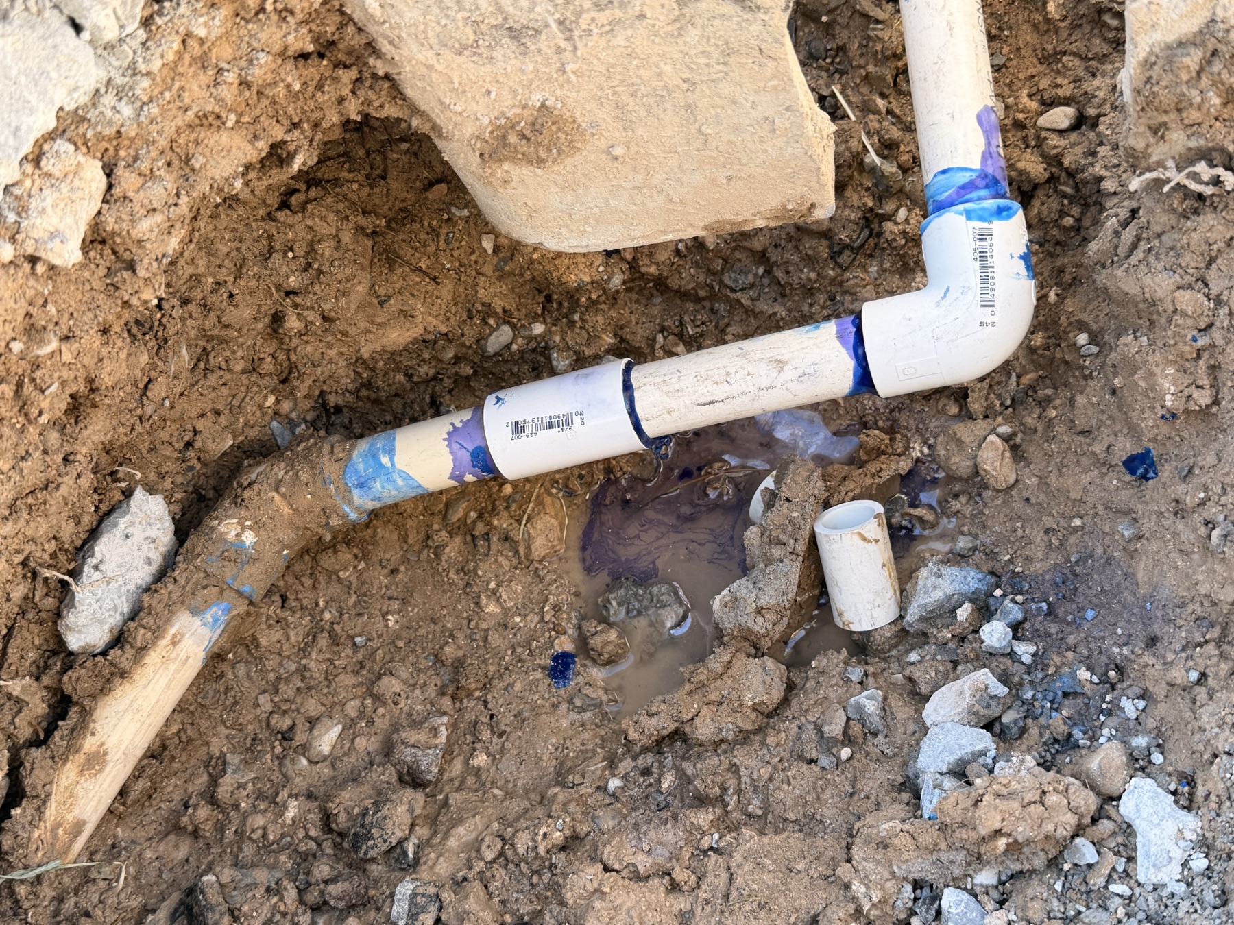 Irrigation leak repair in progress in a residential landscape