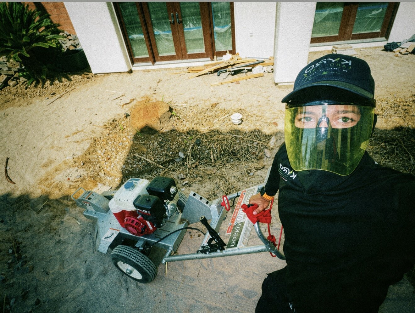 Kyro Landscape crew member with a stump grinder ready for tree stump removal