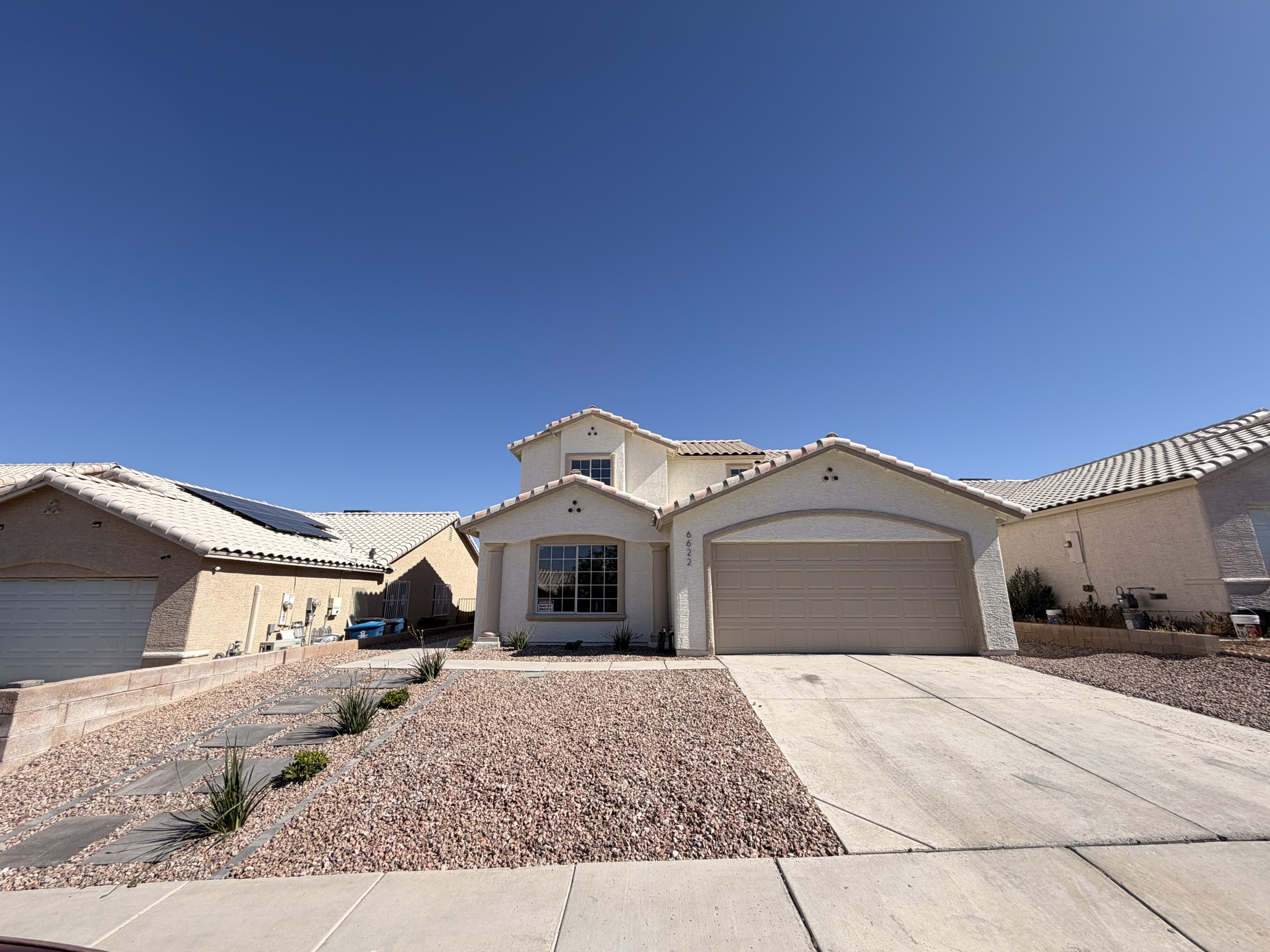 Finished desert landscape refresh with rock, palms, boulders, and turf