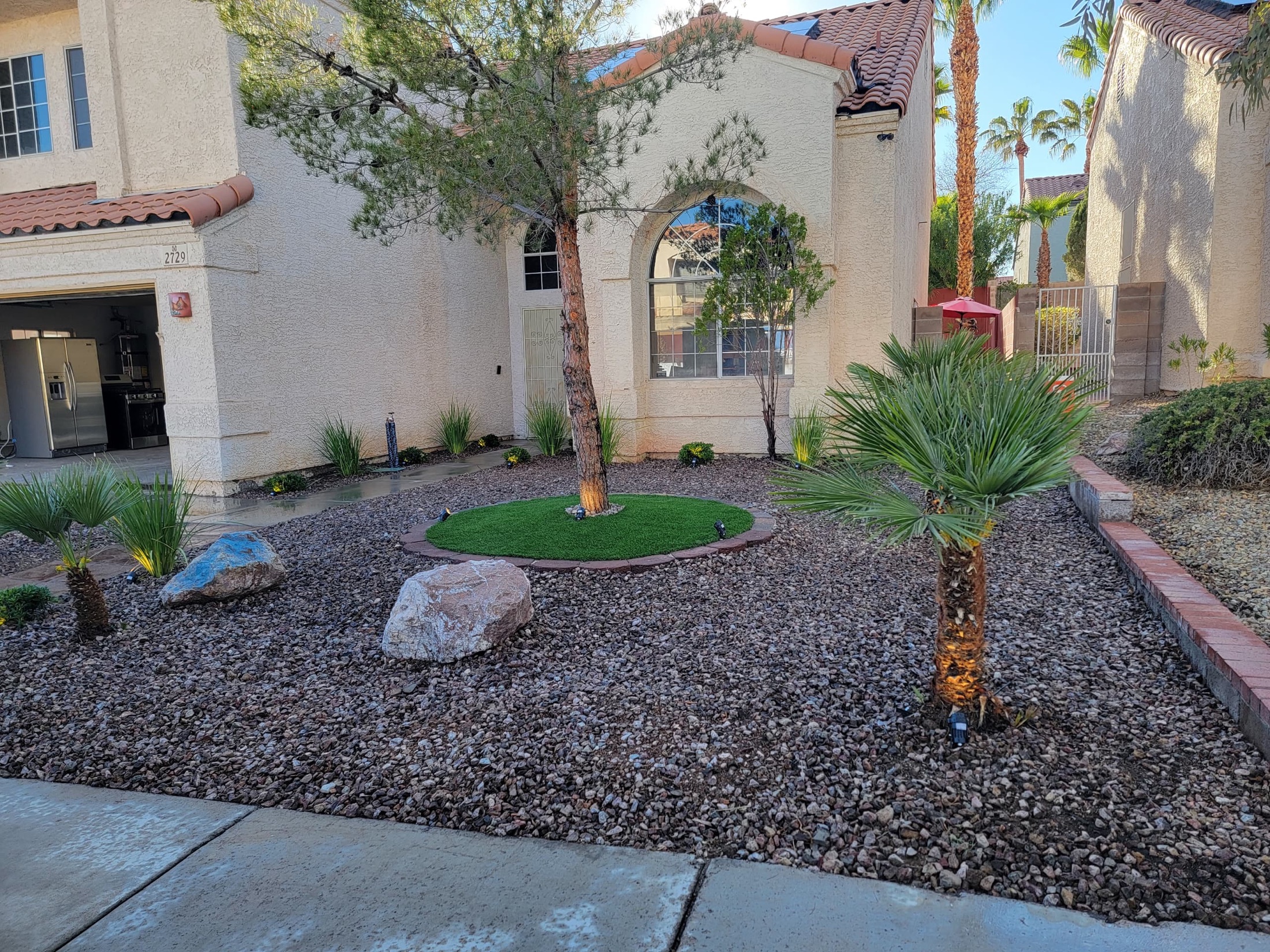 Side yard with decorative rock, concrete pads, and clean open area