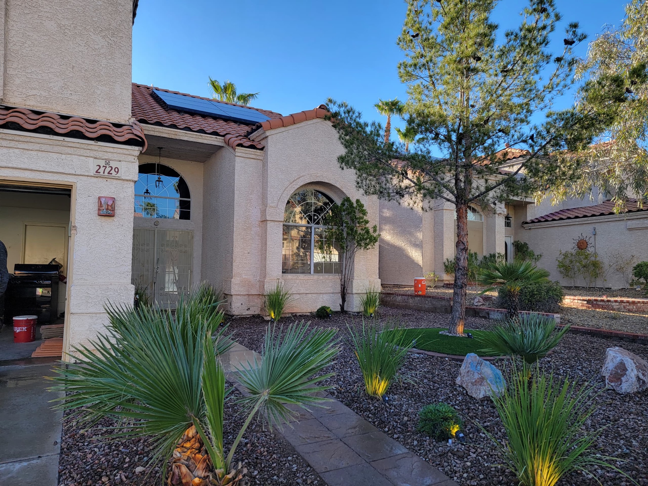 Side yard decorative rock with concrete pads and block wall