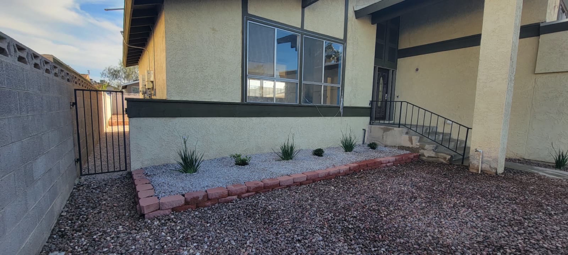 Decorative rock yard with paver walkway and dry river bed