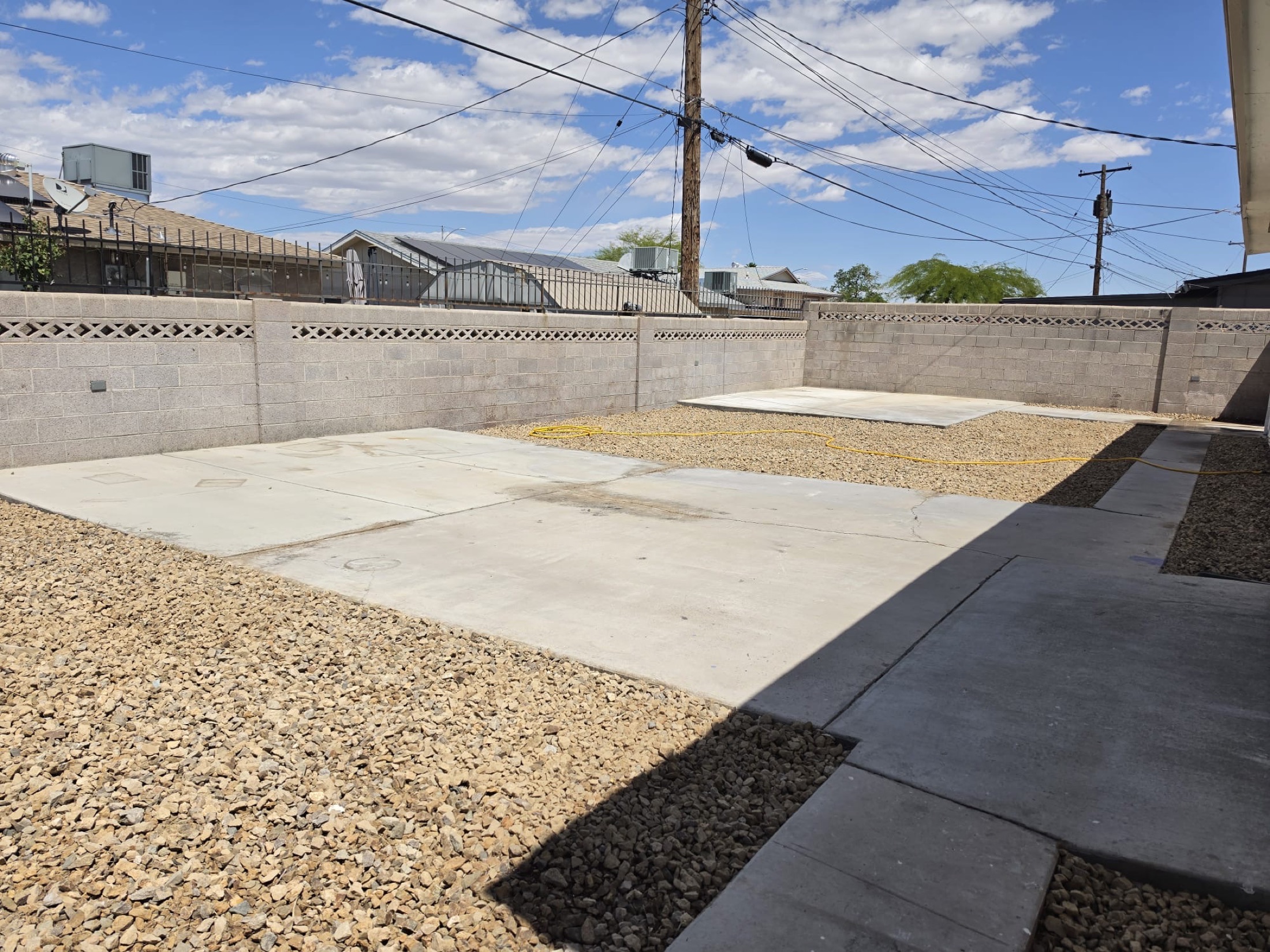 Residential rock installation with pathway, planted bed, and decorative stone ground cover