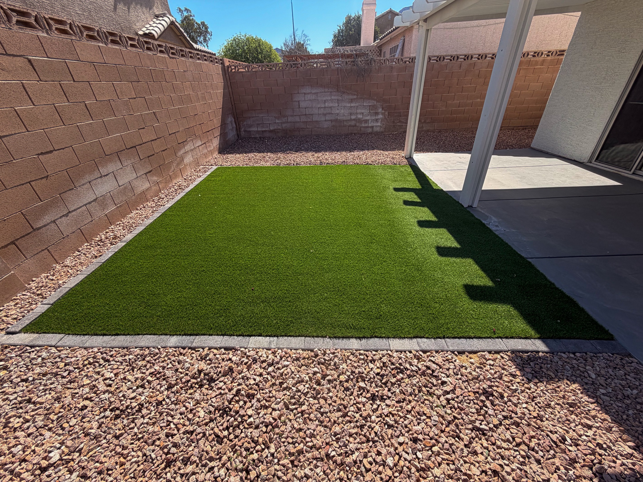 Front yard artificial grass in front of a Las Vegas home with desert planting