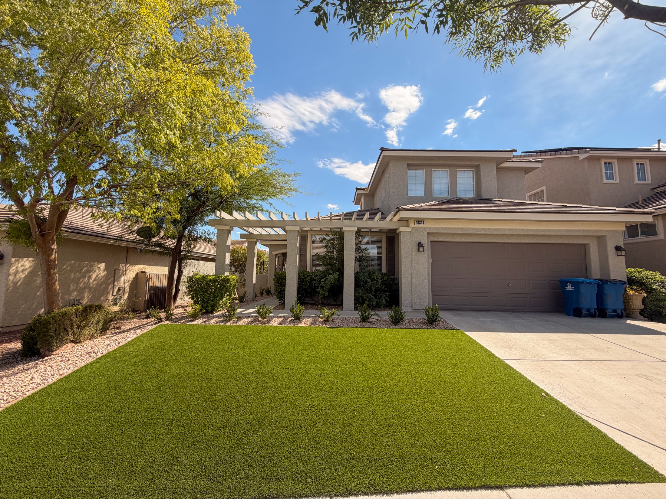 Close view of artificial turf, rock border, and clean patio edge